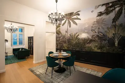 a dining room with a large painting on the wall at Le Baroque - Grand T2 Confort, Lit Queen Size in Castres