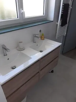 a bathroom with a white sink and a window at Gite Beau Soleil in Roquecourbe