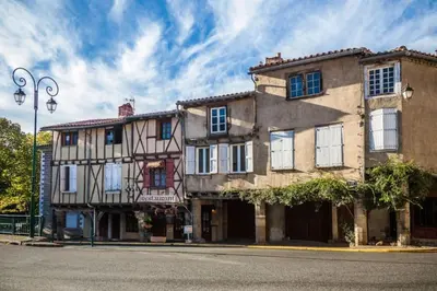 an old building on the corner of a street at Gite Beau Soleil in Roquecourbe