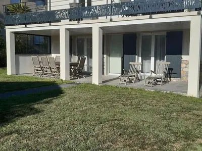 a patio with chairs and tables on a house at Gite Beau Soleil in Roquecourbe