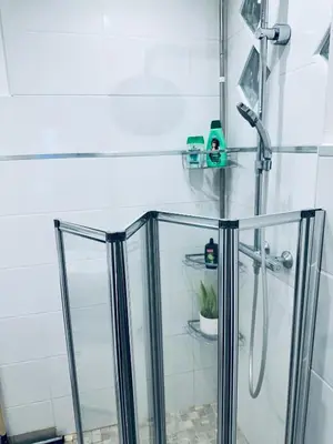 a shower with glass doors in a bathroom at Moderne Mini Maison - Quartier Résidentiel Calme in Lézignan-Corbières