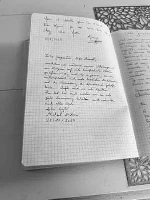 a book with handwriting on it on a table at Moderne Mini Maison - Quartier Résidentiel Calme in Lézignan-Corbières