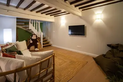 a living room with a teddy bear sitting on the floor at Le Savane - Grand Triplex Confort & Chaleureux, 2 Salons in Castres