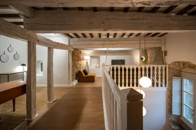 a living room with wooden beams and a staircase at Le Terracotta - Grand Triplex Confort & Chaleureux in Castres