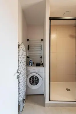 a laundry room with a washer and dryer at Le Terracotta - Grand Triplex Confort & Chaleureux in Castres