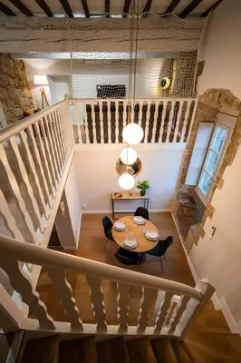a room with a table and a staircase at Le Terracotta - Grand Triplex Confort & Chaleureux in Castres