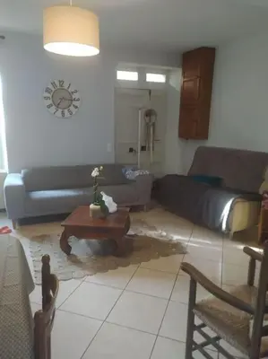 a living room with a couch and a coffee table at Agréable maison au bord de la rivière in Campagne-sur-Aude
