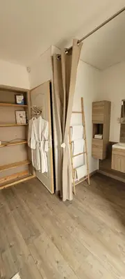 a room with a closet with a door and a ladder at LeMasBlanc, Chambre d'hôtes & jacuzzi privé, au calme, 15min de Carcassonne in Malves-en-Minervois