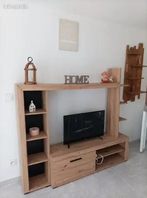 a entertainment center with a tv in a living room at Chez Sabine La Campagne in Narbonne