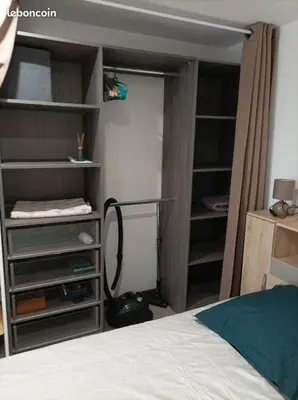 a bedroom with a closet with a vacuum in it at Chez Sabine La Campagne in Narbonne