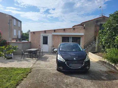 a car parked in front of a house at Maisonnette indépendante 48m2 , parking privé, calme & confort in Lagarrigue