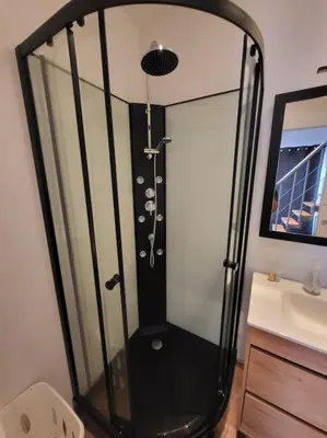 a shower in a bathroom next to a sink at Maisonnette indépendante 48m2 , parking privé, calme & confort in Lagarrigue