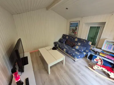 a living room with a couch and a table at Maisonnette indépendante 48m2 , parking privé, calme & confort in Lagarrigue
