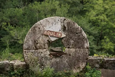 a rock with a street sign on top of it at Moulin de Record in Ferrières