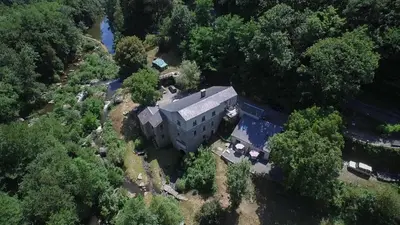 an aerial view of a large house with trees at Moulin de Record in Ferrières