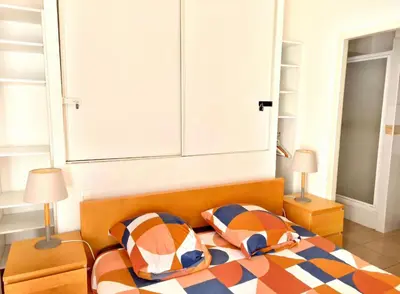 a bedroom with a bed with two pillows on it at Terrasse Privée - 4 Voyageurs - Proche Cité de Carcassonne in Carcassonne