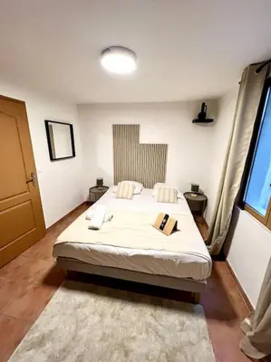 a bedroom with a large bed in a room at Les chambres de la bastide - 202 in Carcassonne