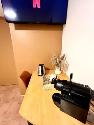 a wooden table with a coffee maker on top of it at Les chambres de la bastide - 202 in Carcassonne