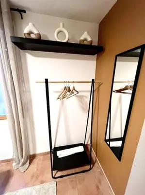 a mirror and a shelf in a room at Les chambres de la bastide - 202 in Carcassonne