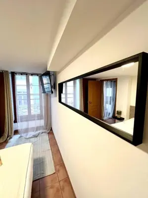 a large mirror on a wall in a room at Les chambres de la bastide - 203 in Carcassonne