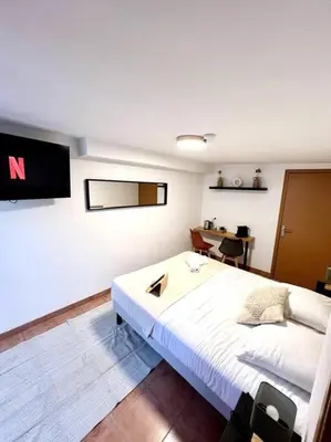 a bedroom with a large white bed and a desk at Les chambres de la bastide - 203 in Carcassonne