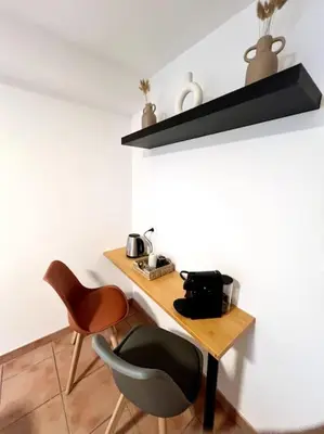 a table and two chairs in a room at Les chambres de la bastide - 203 in Carcassonne