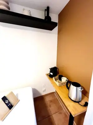 a kitchen with a table with a tea kettle on it at Les chambres de la bastide - 204 in Carcassonne