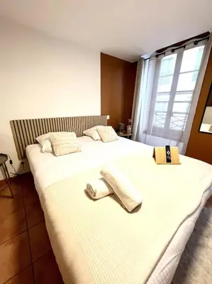 a bedroom with two beds with towels on them at Les chambres de la bastide - 205 in Carcassonne