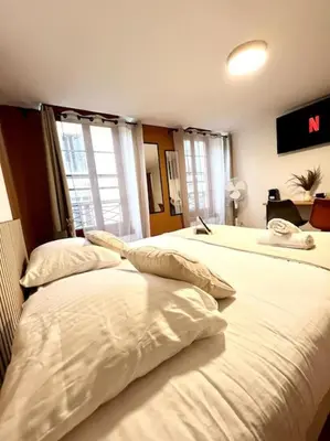two beds in a room with white sheets and pillows at Les chambres de la bastide - 205 in Carcassonne