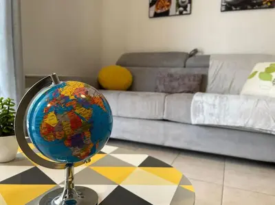 a globe sitting on a table in a living room at T2 Calme et Paisible Parking Piscine in Carcassonne