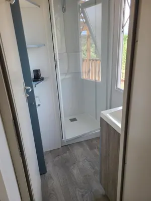 a bathroom with a shower and a sink at Camping Nysa Paziols in Paziols