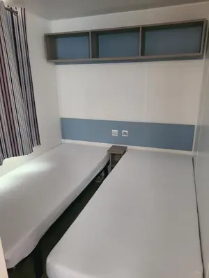 a room with two beds and a window at Camping Nysa Paziols in Paziols