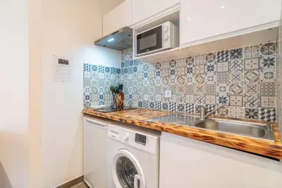 a kitchen with a sink and a washing machine at Le Cocon Coloré in Carcassonne