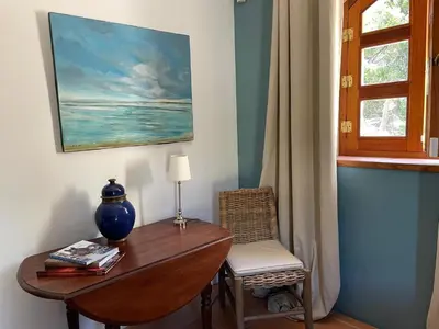 a desk with a lamp and a chair next to a window at Mas Vigneron in Gruissan