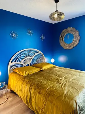 a bedroom with a large bed with blue walls at You&Me hyper centre ville avec draps serviettes ménage final in Narbonne
