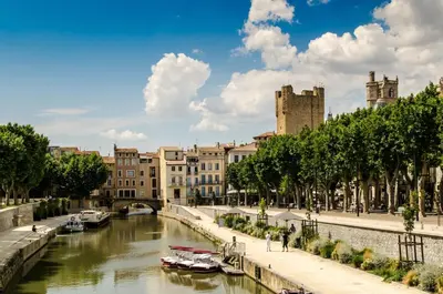 a river in a city with boats in it at You&Me hyper centre ville avec draps serviettes ménage final in Narbonne