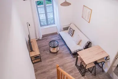 a living room with a couch and a table at La Petite Bastide in Carcassonne