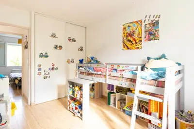 a bedroom with two bunk beds and a mirror at Villa t4 à la campagne in Belleserre