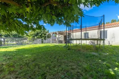 a swing in a yard in front of a building at Villa t4 à la campagne in Belleserre