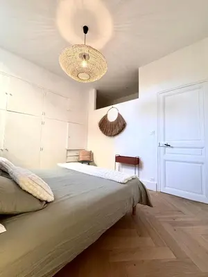 a bedroom with a bed and two lights on the ceiling at Appartement de luxe à deux pas des Halles, quai Valliere in Narbonne