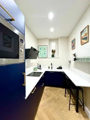 a large kitchen with a sink and a counter at Appartement de luxe à deux pas des Halles, quai Valliere in Narbonne