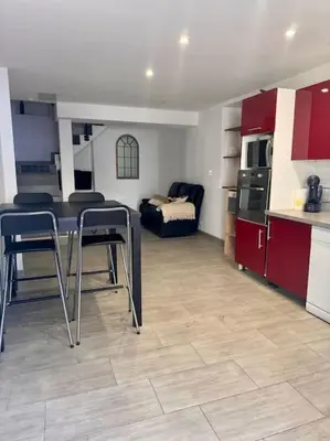 a kitchen with a table and chairs in a room at La Maison de Sainte-Eulalie in Roubia