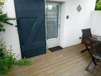 a door to a patio with a table and a chair at Le Grenadier in Ventenac-Cabardès