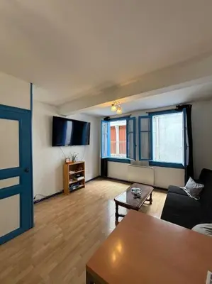 a living room with a couch and a table at Central apartment in Quillan in Quillan
