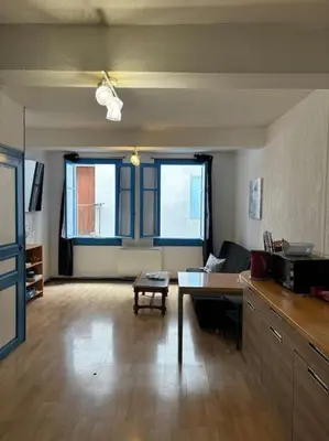 a living room with a couch and a table at Central apartment in Quillan in Quillan