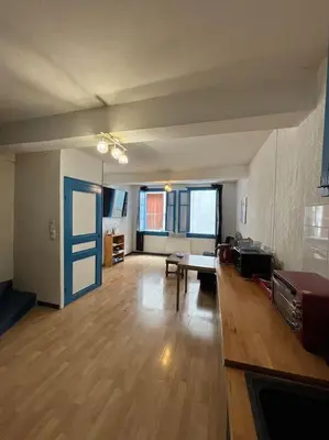 an empty living room with a table and a couch at Central apartment in Quillan in Quillan
