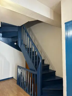a blue staircase in a room with a blue door at Central apartment in Quillan in Quillan