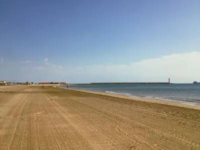 a sandy beach with the ocean in the background at Ancienne maison de pêcheurs in Port-la-Nouvelle