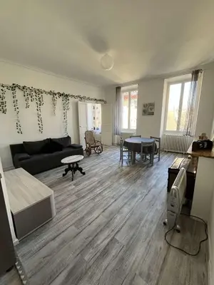 a living room with a couch and a table at Appartement in Limoux