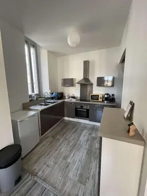 a large kitchen with a sink and a stove at Appartement in Limoux